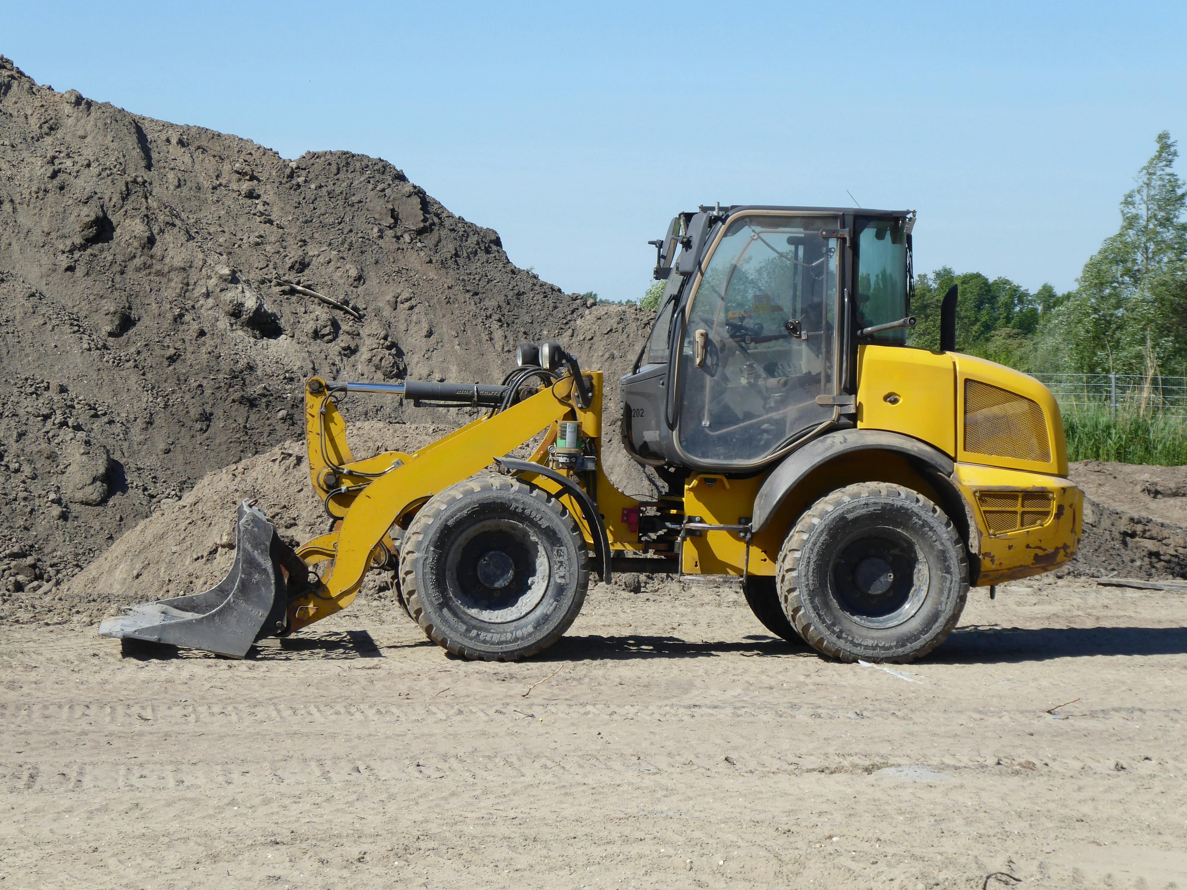 Heavy equipment performing grading and earthwork for a civil infrastructure project